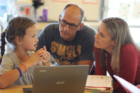 Parents and child learning together at Acton Academy Estero